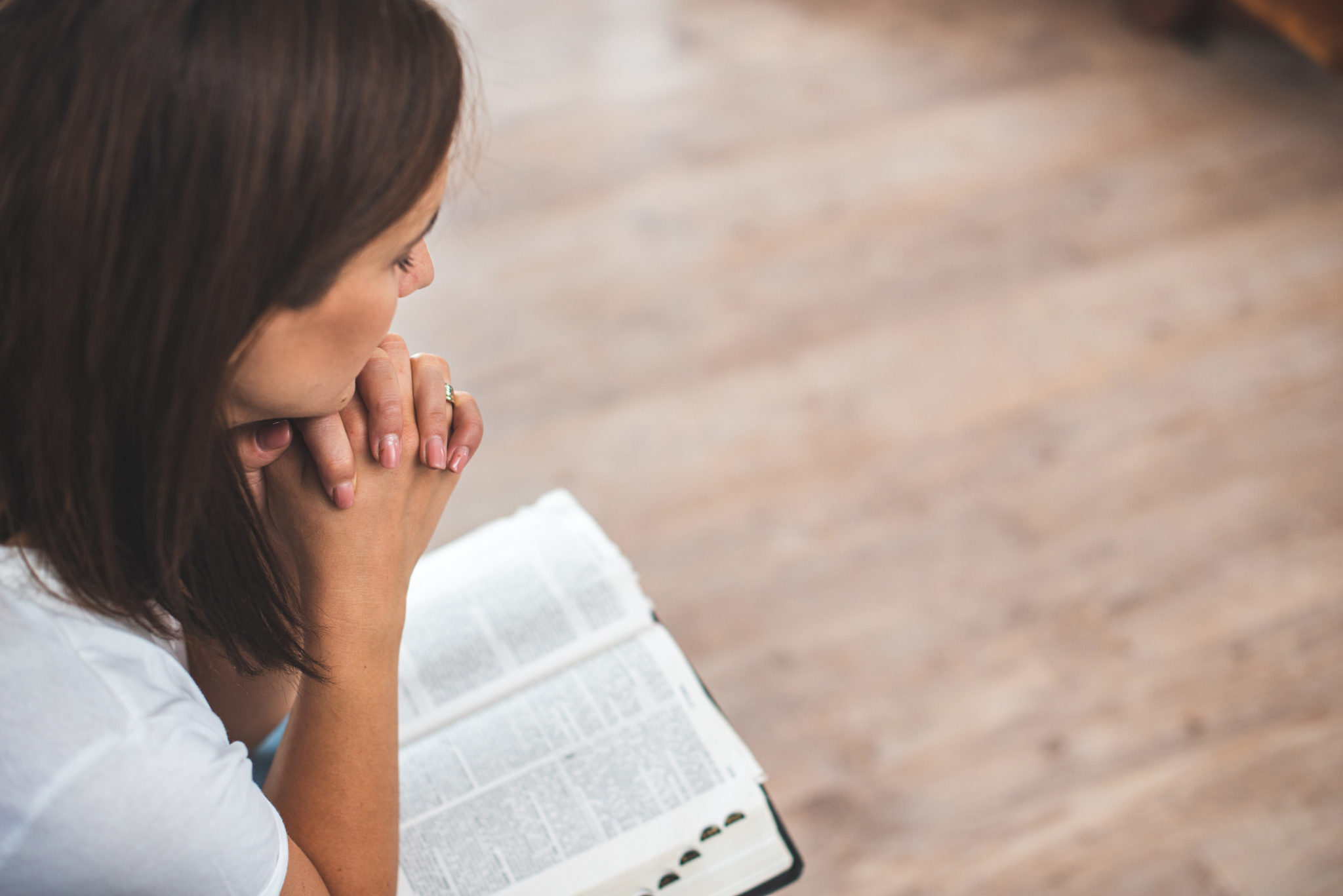 young woman pray with bible relationship with God at home